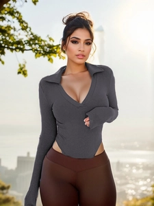 Detail of dark grey ribbed knit bodysuit with deep V-neck polo collar and slim fit texture