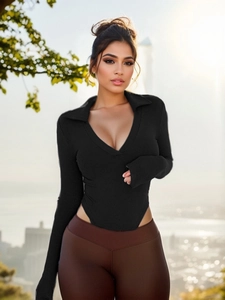 Close-up of black ribbed long-sleeve bodysuit featuring a polo neck and deep V-neckline