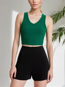 Detail of dark green ribbed knit V-neck sleeveless cropped tank top for women