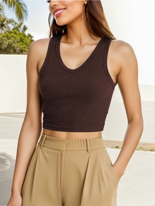 Detailed texture of brown ribbed cotton fabric on a slim fit cropped tank top for women