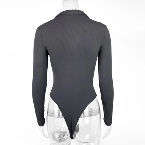Detail view of the ribbed knit fabric and back cut-out of the dark grey long sleeve bodysuit