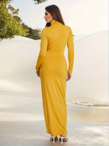 Detail of elegant yellow high neck slim fit maxi dress showing back silhouette and fabric