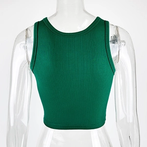 Detail of dark green ribbed crop top showing the racerback cut and high-quality cotton texture