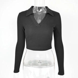 Macro detail of black ribbed knit fabric and polo collar on women's slim crop top