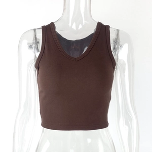 Detail view of the deep brown ribbed knit fabric and V-neckline on the slim crop top