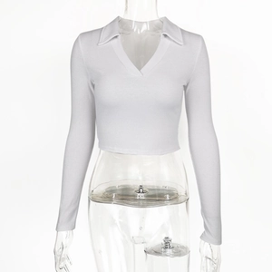 Detail of white cropped knit top with ribbed texture and polo V-neck design