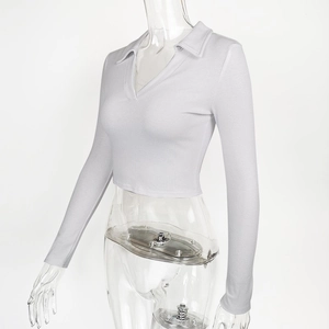 Detailed view of the ribbed knit fabric and polo collar on this cropped long sleeve top
