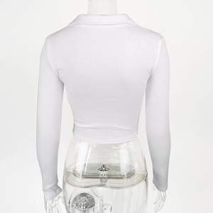 Detail showing white ribbed fabric and cropped back view of a long sleeve polo shirt