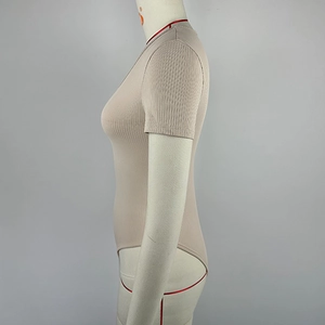 Detail of beige ribbed short sleeve bodysuit showing the texture on a mannequin