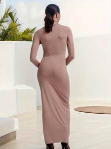 Rear view of a tight dusty pink turtleneck maxi dress highlighting a slim fit silhouette