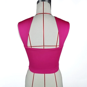 Detail view of the rose pink crop top featuring a slim fit racerback design on a model