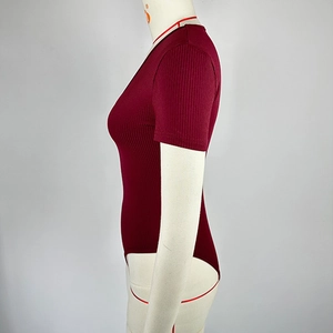 Detail view of wine red ribbed V-neck bodysuit on a mannequin from a side angle