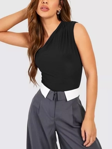 Detail of elegant one-shoulder black bodysuit featuring intricate pleated shoulder textures