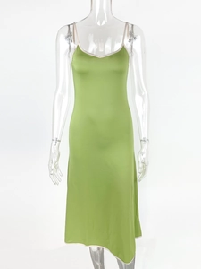 Green satin slip dress with white piping and V-neckline for women on transparent mannequin