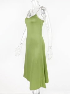 Detail of green satin backless slip dress with contrast beige lace trim and slim fit