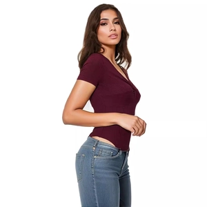 Close-up of wine red ribbed bodysuit with sexy twist front detail and V-neckline