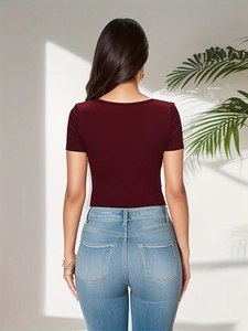 Detail of burgundy ribbed bodysuit and light blue denim jeans from a back view aspect