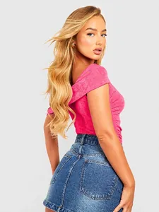 Chic rose pink off-shoulder bodysuit featuring a slim fit and stylish ruched texture