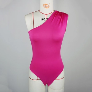 Detail of hot pink one-shoulder bodysuit featuring side pleats and silky fabric texture