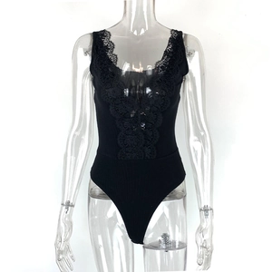 Detail van de diepe V-hals met kanten rand op de zwarte geribbelde bodysuit