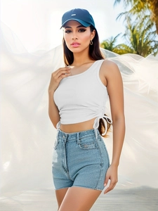 Detail of white ribbed tank top with side drawstring ties and textured fabric closeup