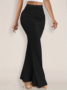 Detailed view of the high-waisted ruched side seams on this black fishtail maxi skirt