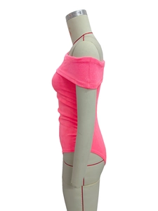 Detailed view of neon pink off-the-shoulder bodysuit with ribbed knit texture on mannequin