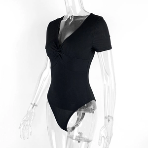 Detail view of the twist knot neckline and ribbed texture on this black V-neck bodysuit
