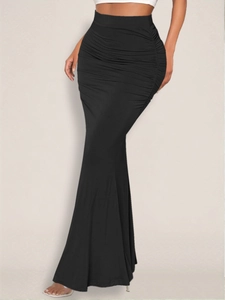 Detail of high waist ruched mermaid skirt in black showing the elegant fishtail hem