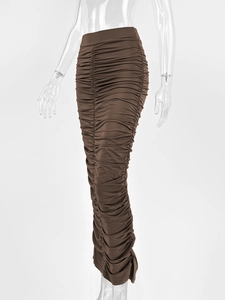 Close-up of high-waist pleated maxi skirt in deep brown with back slit detail