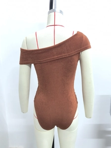 Detail of brown one-shoulder ribbed bodysuit featuring a high-cut back on a mannequin