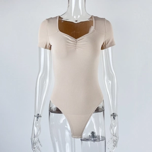 Detail of ribbed knit texture and ruched sweetheart neckline on beige short sleeve bodysuit