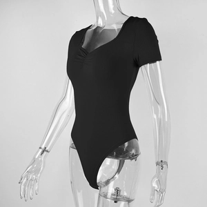 Detail of black ribbed knit bodysuit featuring short sleeves and a cinched V-neck design
