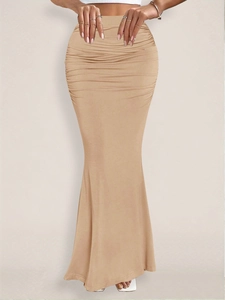 Close-up of ruched khaki mermaid skirt detailing with elegant waist pleats and drape