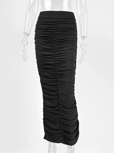 Detail view of the elegant ruched texture and fitted hemline on a black high-waisted maxi skirt