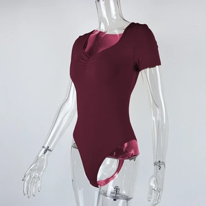 Detailed view of the dark red V-neck bodysuit with ribbed texture and pleated design