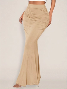 Detail of ruched design on champagne high-waist mermaid maxi skirt with fishtall hem
