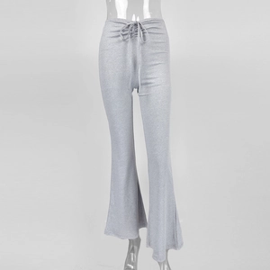 Detail of silver flared trousers with metallic finish and drawstring ruched waist detail