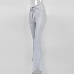 Detailed side view of silver glitter flared pants with high-waisted drawstring design