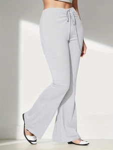 Detailed side view of light grey flared trousers with high-waisted drawstring design