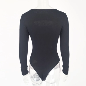 Detail of black ribbed knit bodysuit showing the textured fabric and slim fit design