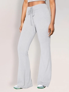 Detail of adjustable drawstring waist on grey pleated flare pants for women