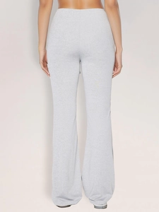 Rear view of grey knit flared trousers showing the slim fit and textured fabric detail