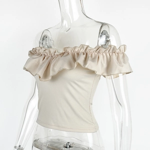 Detail of elegant off-shoulder beige top featuring ribbed fabric and ruffled neckline
