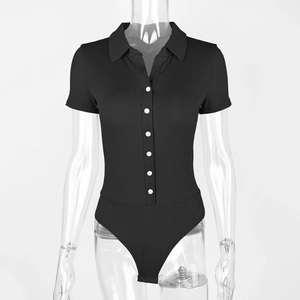 Detail of black ribbed bodysuit featuring contrast white buttons and polo collar