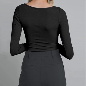 Detail of the back view of a black rib-knit long sleeve bodysuit with a slim fit design