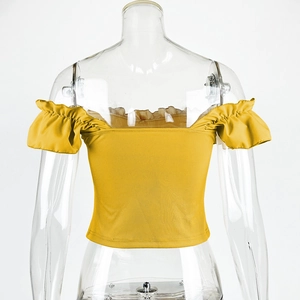 Detail of ginger yellow off-shoulder knit top with ribbed texture and ruffle puff sleeves
