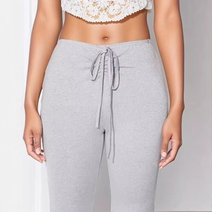 Women's light grey high-waisted ribbed knit flare pants with drawstring waist detail