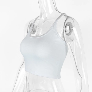 Detail showing white ribbed fabric texture and slim fit design of a cotton crop top
