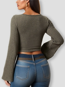 Back view of a tight green ribbed crop top with long flared sleeves and thick elastic fabric